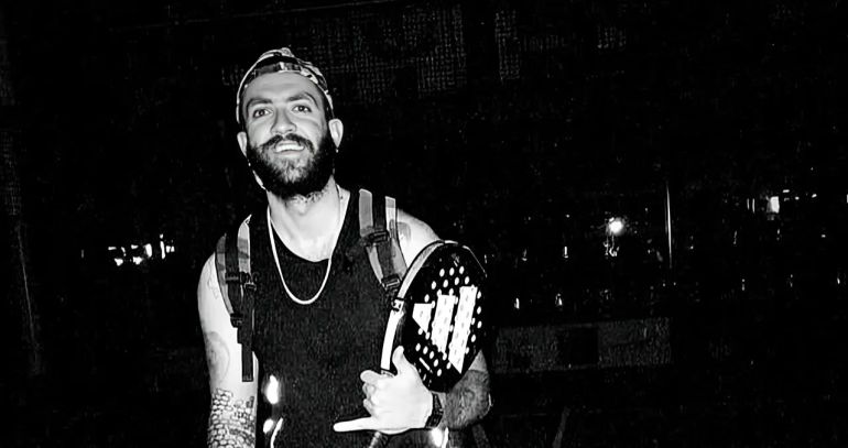 A black-and-white image of Parsa, a tennis player, holding a racket